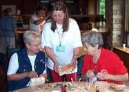 Vermonter Dona Nazarenko, center, explains the fine points of working with birch bark to Pam Parman and Sharron Kirby.