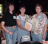 It takes three to make to make this basket: Patti Hawkins to teach it, Lisa Reid to weave it, and Miss Jimmie to kibbitz!
