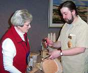 Dianne Strickland shows Eric Taylor how to attach the handles on his Cottage Basket.