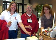  Jettie Fulton, Linda Rolfe and Janie Jones go for the same prize at the raffle table.  Jettie was a BIG winner in the Volunteer Raffle.