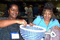 Looks like a Patti Hawkins basket that Madeline Mason is working on while her pal, Marion Goldston, wends her way through a ribbed basket.
