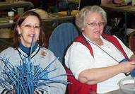 Weaving with reed and wire are Kathryn Jacoby and Kathy Cornehl