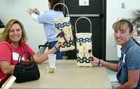 Proud students display their finished wall baskets, taught by Zoe Crane