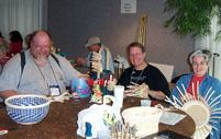 Roger Buchanan, Pamela King and Lisa Ffrench exchange weaving tips and laughs in the Open Weave area.